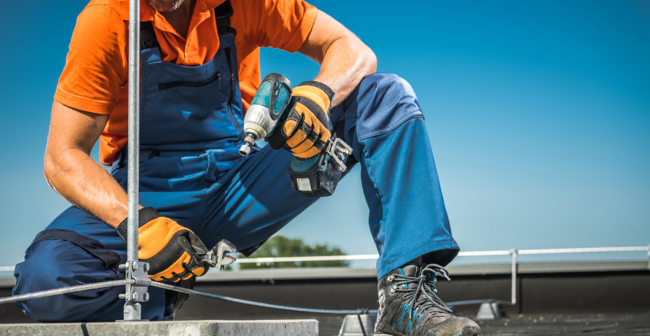 Roofer holding drill.