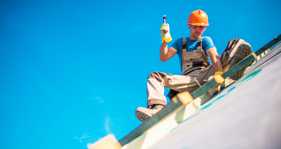 Roofer swinging hammer.