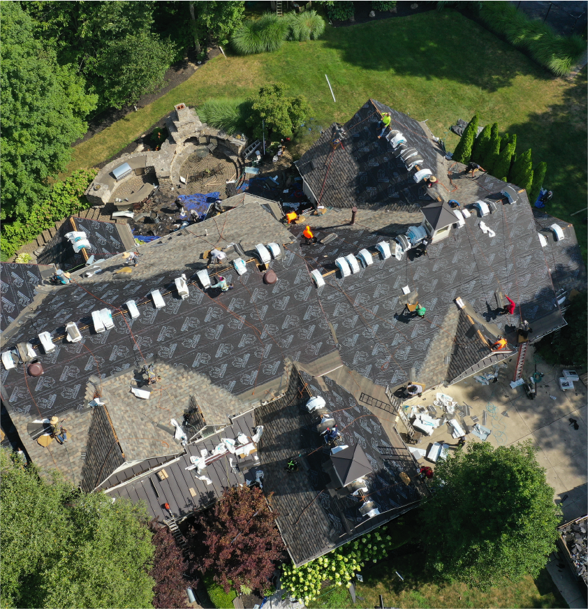 Aerial view of a large residential roofing project in progress.